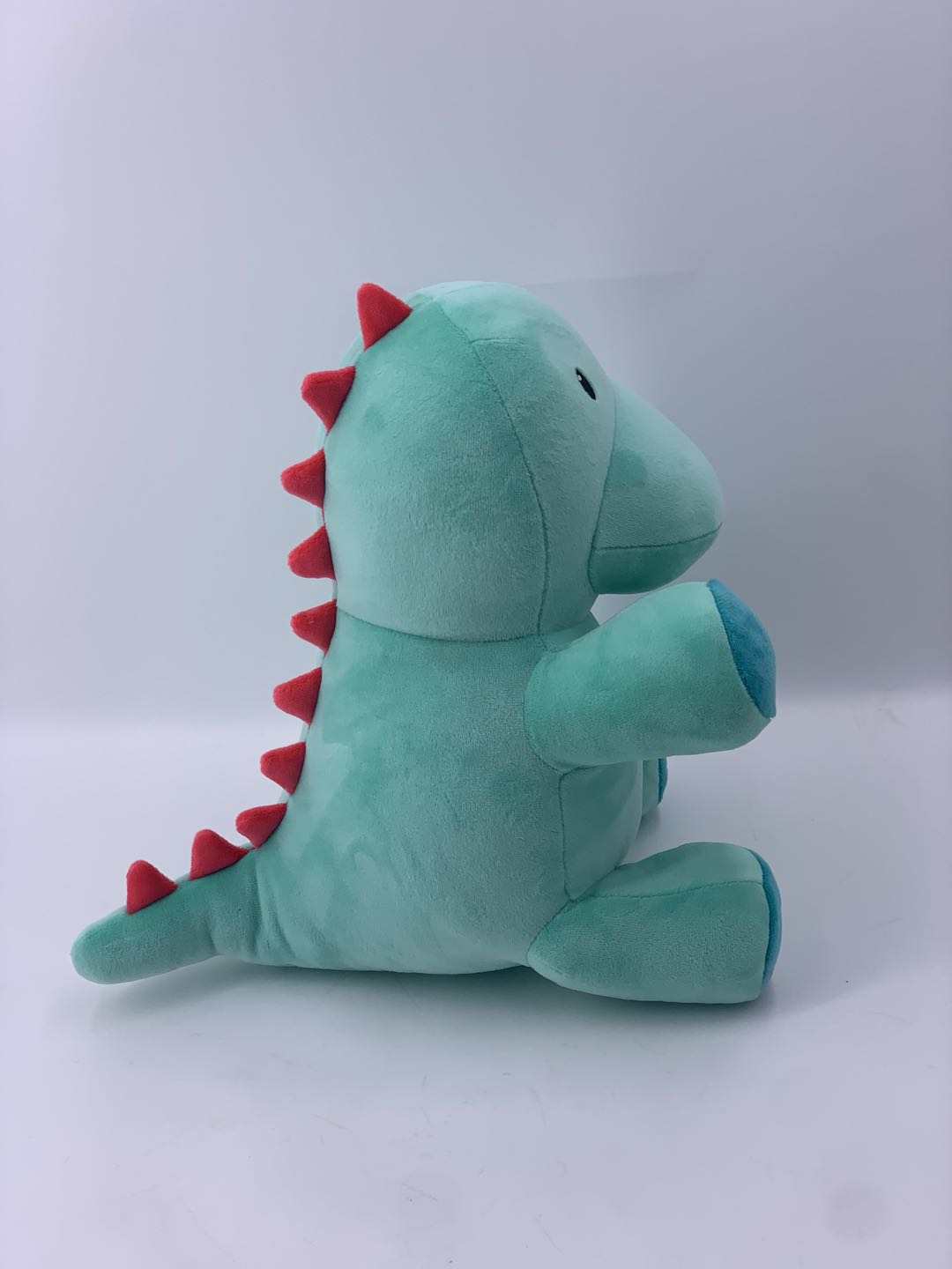 10" Genosaurus plush stuffed animal side view showcasing its friendly design, soft fabric, and intricate details from the Jurassic era